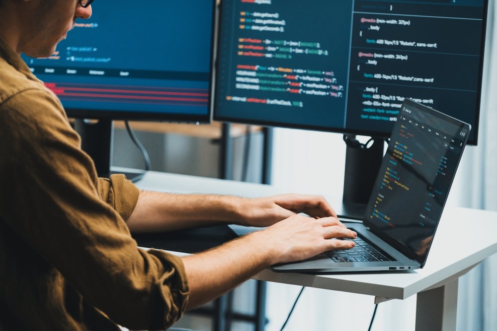 It,Developer,Working,Online,Software,Development,On,Pc,Monitors,At