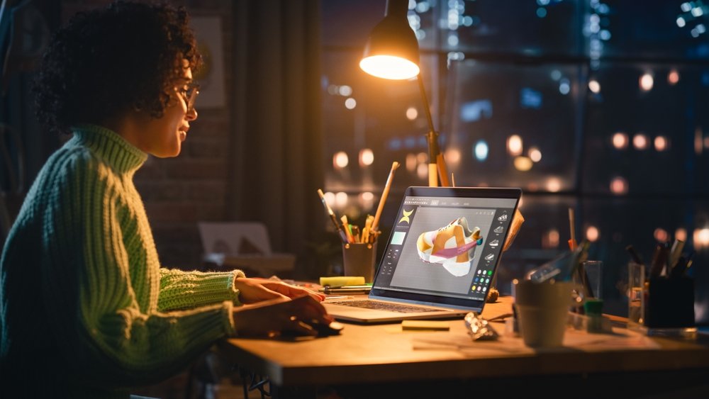 Latina,Female,Designer,Working,On,Laptop,,Screen,Showing,Editing,Software